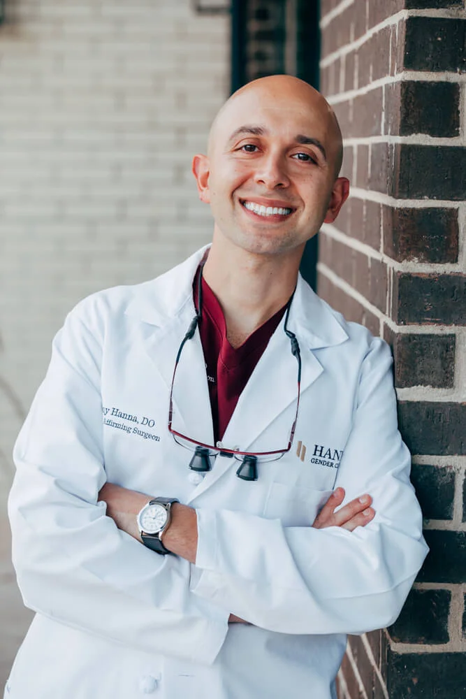 Dr. Hanna smiling and leaning against his gender affirming clinic